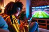 Gen Z football fan checking phone during WC match