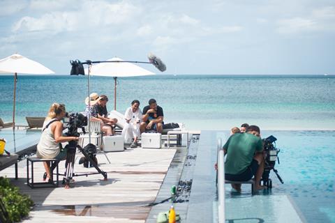 Camera Assistant Natalie Alderson and Camera Op Tristam Cones film guests by the pool